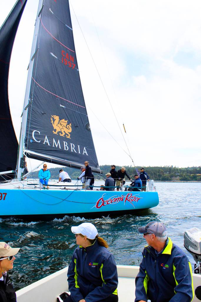 A chase boat takes in the start of competition at the Monday opening of Race Week. The annual event attracts sailors from the Northwest and Canada who compete daily in Penn Cove. See story on page 3.