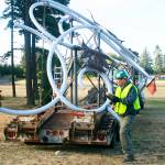 Justin Hunter, with Architectural Elements, helps prepare the &ldquo;Autumn Leaves&rdquo; sculpture for installation Tuesday morning, along Highway 20, near the North Whidbey Middle School play fields. Photo by Daniel Warn/Whidbey News-Times