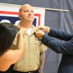 In a ceremony at Naval Air Station Whidbey Island, actor Gary Sinise pins the collar of Tobias Stiewing as he&rsquo;s promoted from Petty Officer second class to first class. Stiewing&rsquo;s wife, Kimberly, also participated. Sinise later performed with his Lt. Dan Band at an outdoor concert sponsored by USO and Gary Sinise Foundation. Photo by Patricia Guthrie/Whidbey News-Times