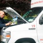 Camryn Engle, autogas coordinator for Blue Star Gas, connects a laptop to one of Whidbey-SeaTac Shuttle & Charter&rsquo;s vehicles that it recently converted to propane. The laptop connects to added components in the shuttle&rsquo;s engine to gauge the vehicle&rsquo;s functionality. Photo by Daniel Warn/Whidbey News-Times
