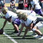 The offensive line gets ready to fire off the ball. (Photo by John Fisken)