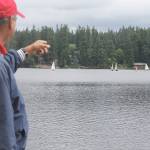 Bob Rodgers, commodore of the South Whidbey Yacht Club, gestures to a class of youth sailors at Goss Lake onThursday. Sailors have moved to Goss Lake due to a toxic algae bloom at Lone Lake. Photo by Evan Thompson / Whidbey News Group