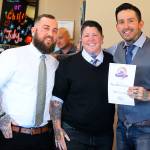 Seth Smith, Molly Vigallon and William Lloyd of Nite Owl Tattoo accept an award for Best Tattoo Shop. Photo by Megan Hansen/Whidbey News-Times