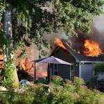 Kyle Jensen / The Record &mdash; The neighboring home also caught fire after propane tanks went up in flames.