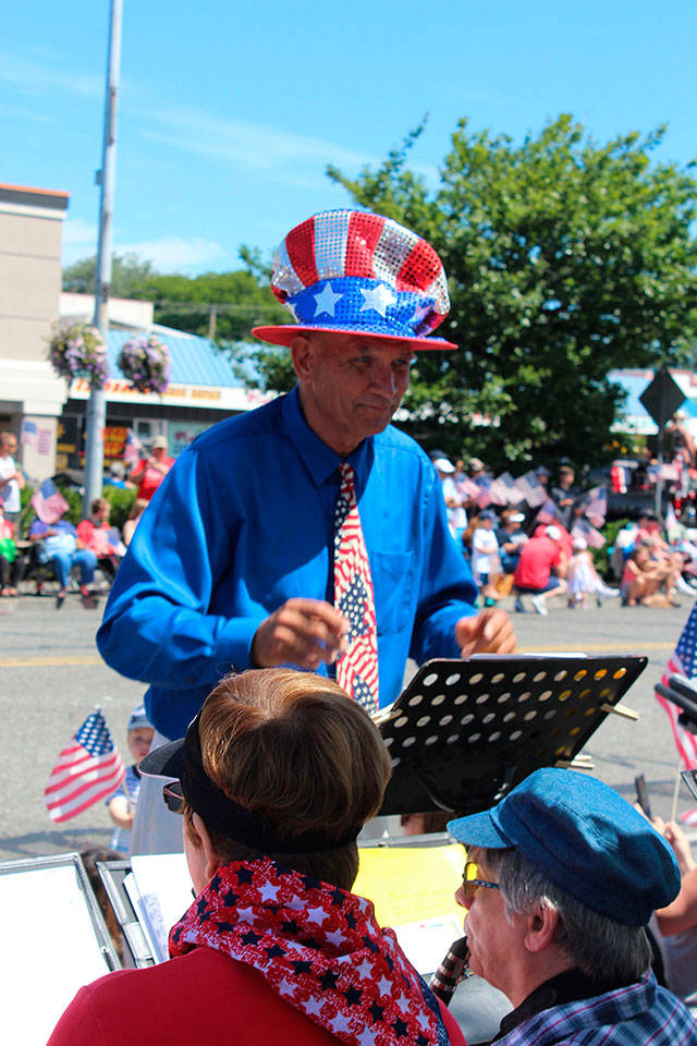 The top hat and tie of band leader Bruce Seltveit leaves no doubt as to what day and which parade the All-Island Community Band performs for from the sidelines. It plays at many local festivities.