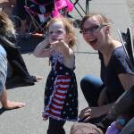Emmalyn Carr and her mother, Sarah Carr, react as two military jets roar overhead to kick-off the Oak Harbor Fourth of July parade.