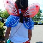 Older sister Kaili Groves, 7, shows off the back of her butterfly Fourth of July outfit.