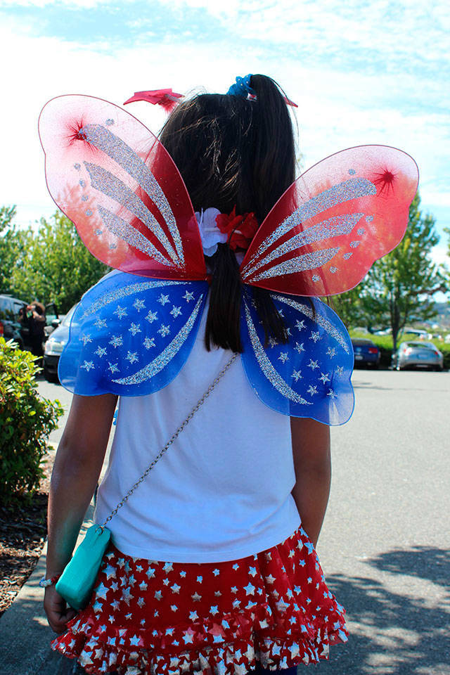 Older sister Kaili Groves, 7, shows off the back of her butterfly Fourth of July outfit.