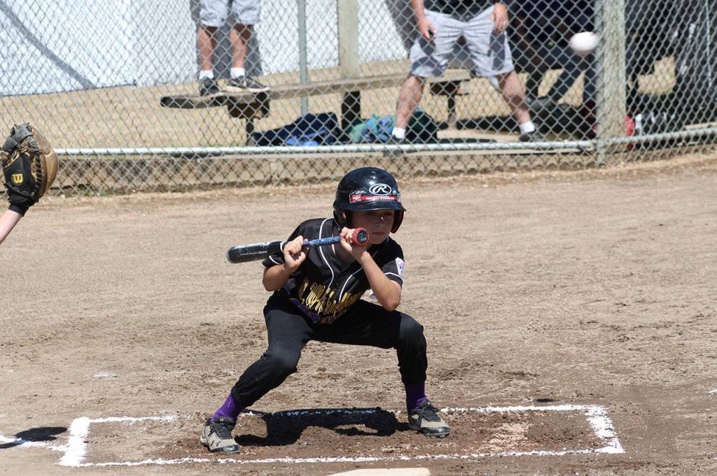 Alex Jenkins ducks out of the way of a high pitch. (Photo by Jim Waller/Whidbey News-Times)