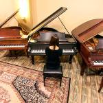Liv Hwang tries out one of the more than 30 vintage pianos on display in downtown Everett. Lloyd Boyd of Coupeville is selling off the collection of pianos that his brother rebuilt over 50 years in the music business.                                Photo by Kevin Clark/The Herald