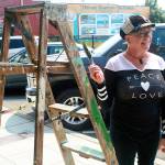 Therese Kingsbury, director of Rogue One Guerrilla Arts Network, prepares to scrape old pain off of Wind and Tide&rsquo;s facade for her non-profit Thursday. Rogue One specializes in beatifying Oak Harbor by &ldquo;Changing private places into public spaces.&rdquo; Photo by Daniel Warn/Whidbey News-Times