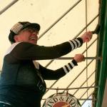 Photo by Daniel Warn/Whidbey News-Times                                Therese Kingsbury, scrapes old pain off of Wind and Tide&rsquo;s storefront Thursday, a project for her non-profit, Rogue One Guerrilla Arts Network.