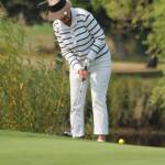 Monique Franssen, who finished with the best net score among the women in flight two, drops in a putt. (Photo by Jim Waller/Whidbey News-Times)