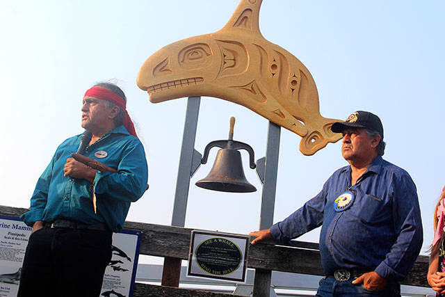 Lummi Nation members Jewell James (left) and Douglas James, Jr. in front of the Coupeville whale bell speaking on the cultural significance of returning Tokitae/Lolita to her ancestral home. Photo by Patricia Guthrie/Whidbey News-Times