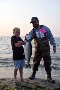 Kyle Jensen / The Record &mdash; Beckett Spjute (left) and Alex Spjute (right), visiting from California, hold up Beckett Spjute&rsquo;s catch. The Spjute family&rsquo;s friend from Seattle took them fishing at Bush Point Thursday evening.
