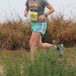 Oak Harbor&rsquo;s McKenzie Schneider runs along the bluff. (Photo by Jim Waller/Whidbey News-Times)