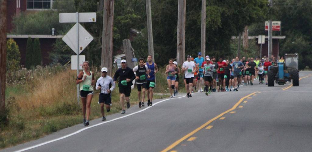 The race wouldn&rsquo;t be complete without sharing the road with a tractor. (Photo by Jim Waller/Whidbey News-Times)