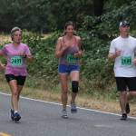 Patty Hengel, left, Melissa Kmetz and Ryan Terpening get back on the road after a trip through Rhododendron Park. (Photo by Jim Waller/Whidbey News-Times)