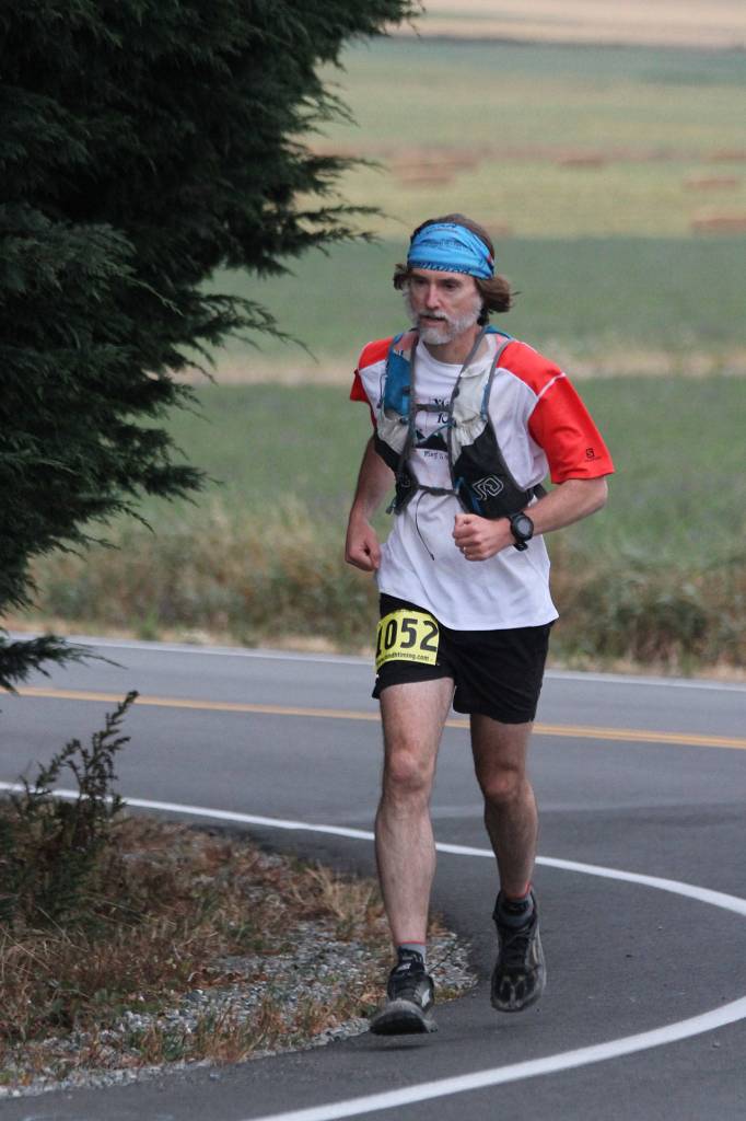 Dr. Peter Keating of Oak Harbor turns onto Sherman Road during the marathon. (Photo by Jim Waller/Whidbey News-Times)