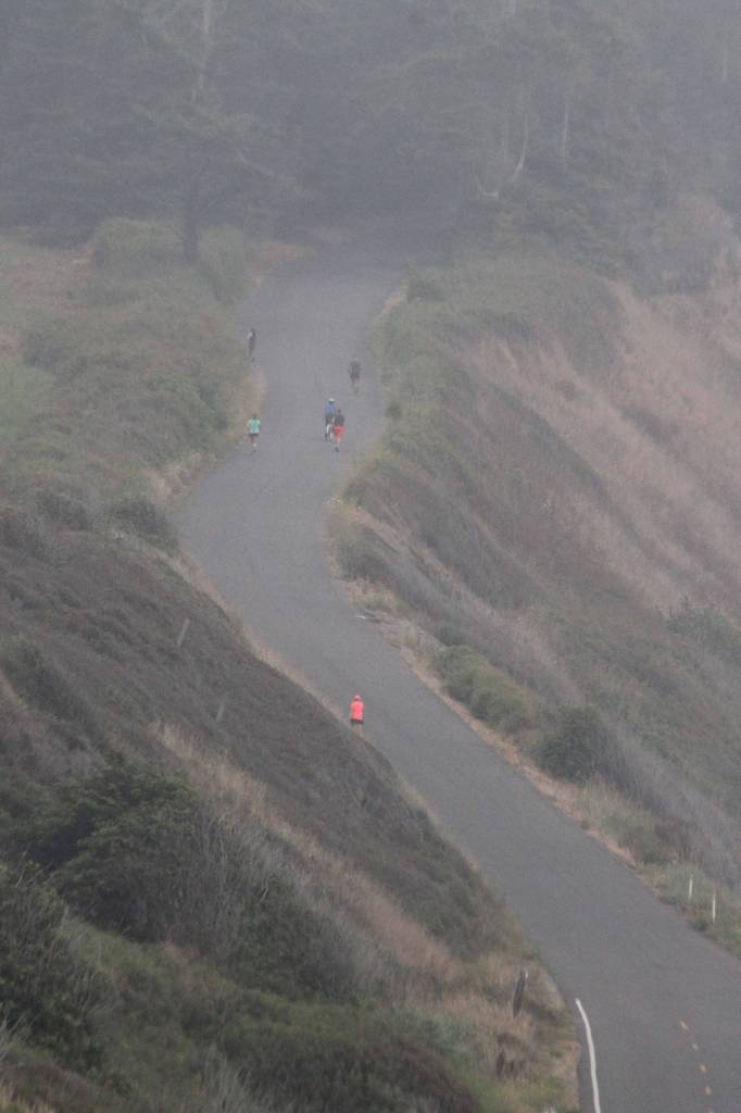 Marathoners work their way through the fog and up Hill Road. (Photo by Jim Waller/Whidbey News-Times)