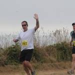 Brent Johnston, left, has a high-five for the photographer. He is joined on the bluff trail by Robert Stone. (Photo by Jim Waller/Whidbey News-Times)