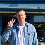 Macklemore flashes the peace sign outside Island County District Court Monday after paying a fine for driving with a suspended license. Photo by Laura Guido/Whidbey News-Times