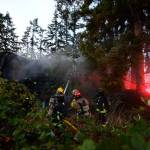 Justin Burnett/The Record &mdash; South Whidbey Fire/EMS firefighters work to extinguish a house fire on Honeymoon Bay Road on Wednesday evening. The fire was deemed &ldquo;suspicious&rdquo; in nature.