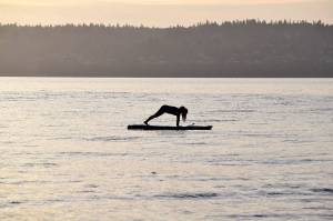 Kyle Jensen / The Record &mdash; Aja Stewart, of Clinton, holds a yoga pose on the water during a Friday morning session.