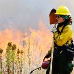 Michelle Boderck, from the Center for Natural Lands Management, assists Thursday with a controlled burn at the Admiralty Inlet Natural Area Preserve. The burn is part of the Whidbey Camano Land Trust&rsquo;s effort to restore prairie lands on the island. Photo by Laura Guido/Whidbey News-Times