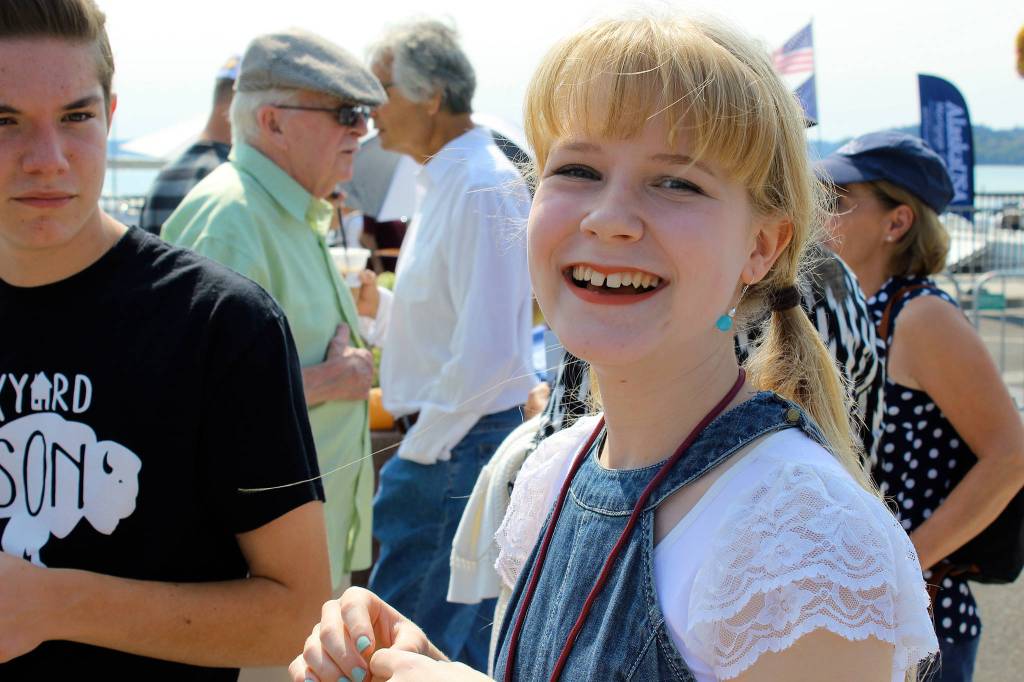 Rosahlee Van Kappel, 14, greets her friends after singing and playing ukulele Sunday morning.