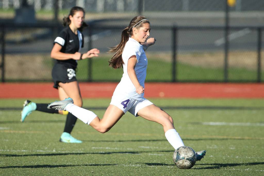 Oak Harbor&rsquo;s Jenna Cooley boots the ball for the Wildcats. (Photo by John Fisken)