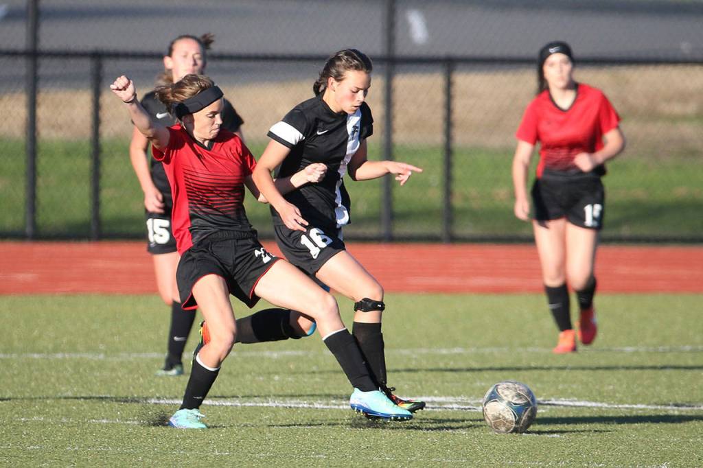 Coupeville&rsquo;s Mallory Kortuem, left, challenges a South Whidbey player. (Photo by John Fisken)