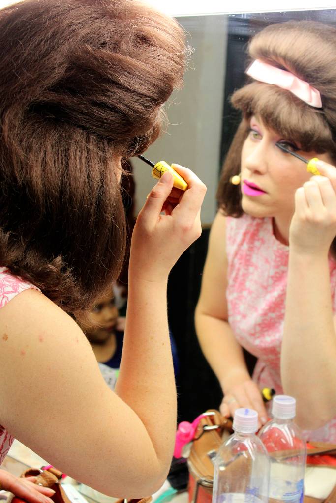 Erin Pitts becomes pretty in pink before a preview show of Beehive last week. Opening is 7:30 p.m. Friday.