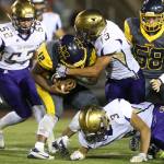 Aaron Martinez (13) takes down Mariner&rsquo;s Josiah Pesterfoff with help from Isaac Gomez (52), Andrew Miller (3) and Darian Matsushita (8). (Photo by John Fisken)