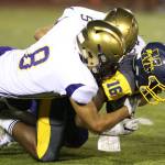 Darian Matsushita (8) and Isaac Gomez stop Mariner&rsquo;s Amory Brown. (Photo by John Fisken)
