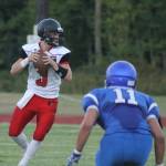 Hunter Downes looks for an open receiver as South Whidbey&rsquo;s Hunter Ewert (11) closes in. (Photo by Evan Thompson/Whidbey News Group)