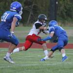 Coupeville&rsquo;s Shane Losey fights off the tackle of Bodie Hezel (8) as Clay O&rsquo;Brien (31) races in to help. (Photo by Evan Thompson/Whidbey News Group)