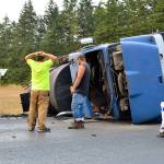 An Asphalt Quality Sealers truck turned on its side Thursday, spilling asphalt sealcoating into a field near Libbey Road. Photo by Laura Guido/Whidbey News-Times
