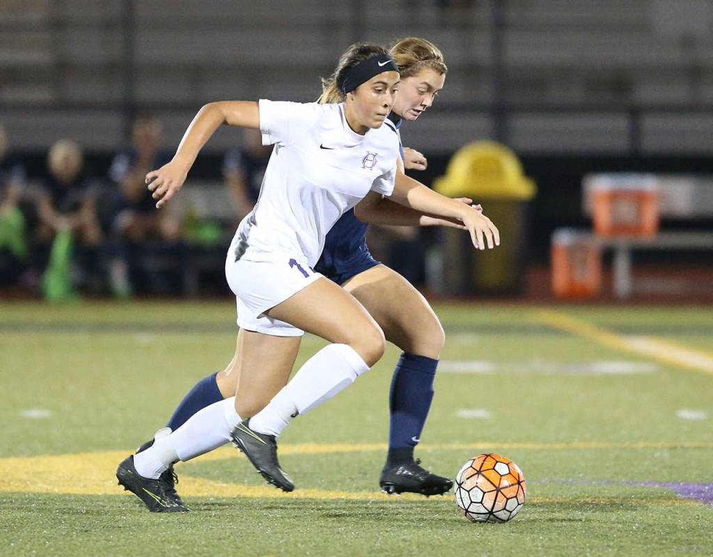 Mikhaela Cortez races by a Squalicum player. (Photo by John Fisken)