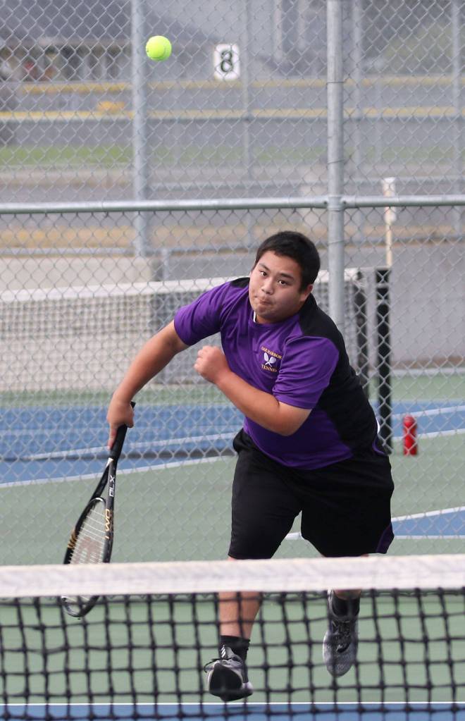 John Bird serves in second singles. (Photo by John Fisken)