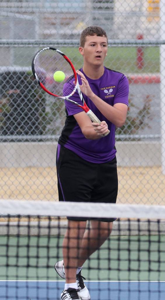 Trenton Cone returns a shot in his first doubles match. (Photo by John Fisken)
