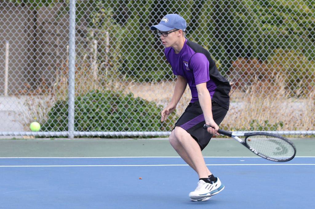 Claude Thrailkill prepares to return a shot in third singles. (Photo by John Fisken)