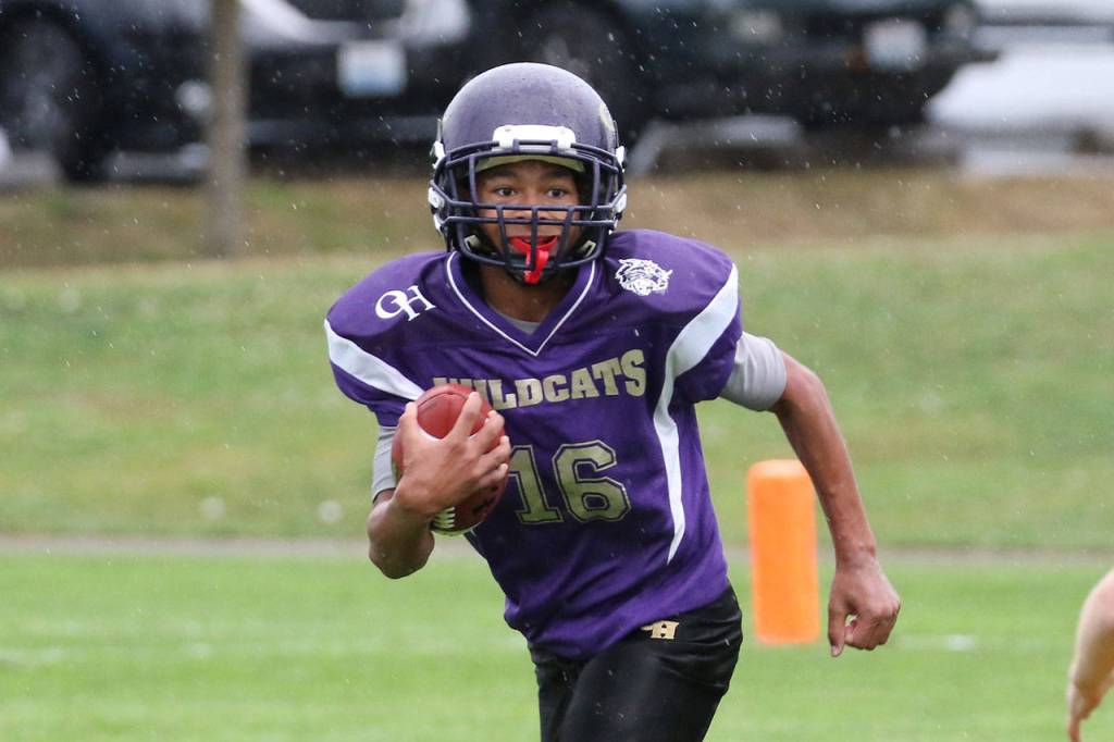 Junior Ezra Kitchens looks to the end zone for Oak Harbor. (Photo by John Fisken)