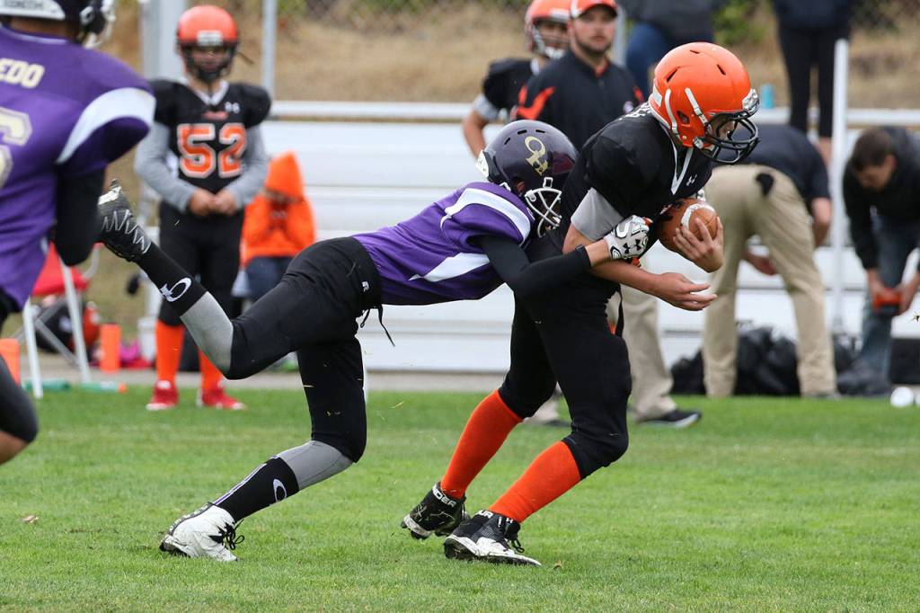 Will Rankin brings down a Granite Falls Senior runner. (Photo by John Fisken)