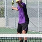 Ridgely Briddell prepares to serve in the second doubles match. (Photo by John Fisken)