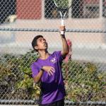 Edison Soliman serves during his third doubles win. (Photo by John Fisken)