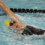 Oak Harbor&rsquo;s Olivia Tungate zips to an easy win in the 100-meter backstroke. (Photo by John Fisken)
