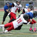 Cameron Toomey-Stout (11) has developed into a two-way starter for the Wolves. Above, he helps bring down a Bellevue Christian ball carrier last fall. (Photo by John Fisken)