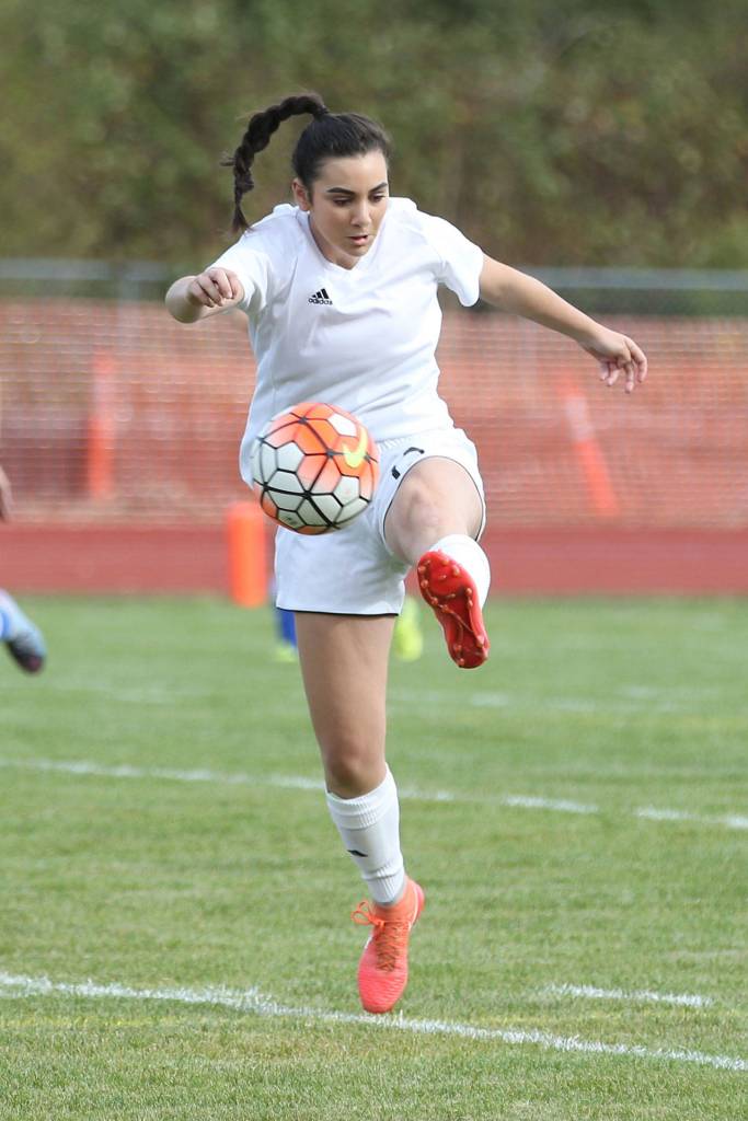 Kalia Littlejohn, who scored three goals in the match, boots the ball for Coupeville. (Photo by John Fisken)
