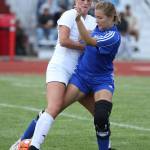 Lindsey Roberts, left, tangles with an MVC player. (Photo by John Fisken)